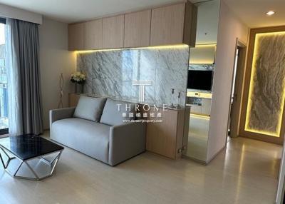 Modern apartment interior showing open-plan living space with kitchen, living room and stylish furnishings