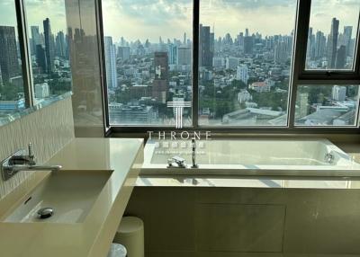 Modern bathroom with large windows overlooking the city