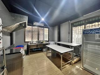 Spacious industrial-style kitchen with stainless steel counters and commercial-grade appliances