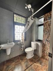 Modern bathroom interior with a combination of concrete and brick textures