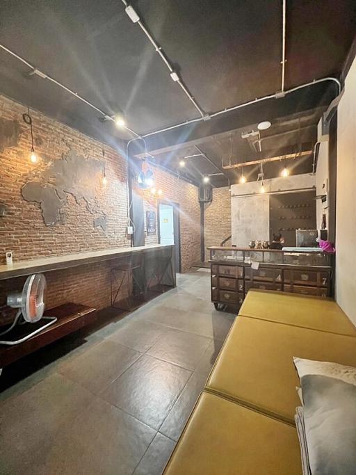 Modern industrial-style interior with exposed brick walls and high ceiling