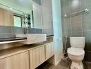 Modern bathroom interior with clean lines featuring sink, toilet, and shower area