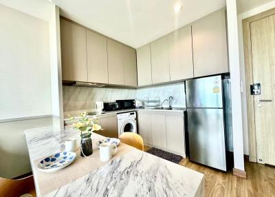 Modern kitchen with marble countertop and stainless steel appliances