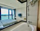 Modern bathroom with a bathtub and a view of the outside through a large window