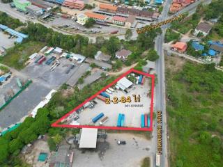 Aerial view of a vacant land plot with marked boundaries in an urban area