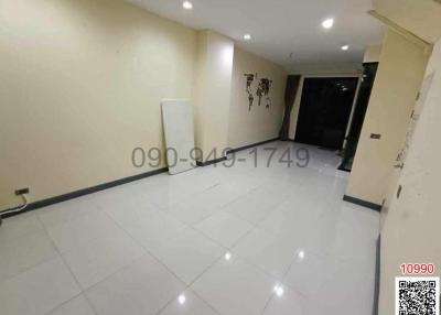 Spacious and brightly lit empty room with glossy floor tiles