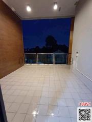 Empty room with tiled flooring and large window at dusk