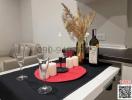 Modern kitchen with a dining setup including wine and elegant decor