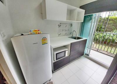Compact kitchen space with modern appliances and outdoor access