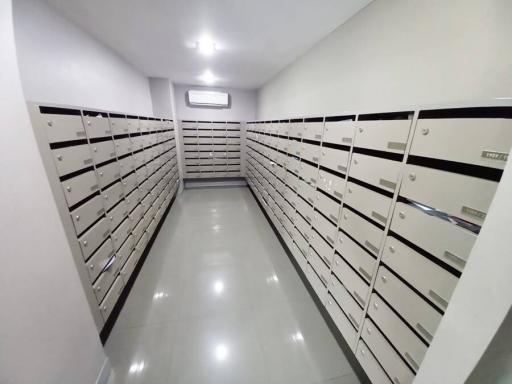 Spacious mailroom with tiled floors and mailbox units