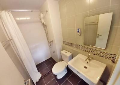 Compact bathroom with white fixtures and tile flooring