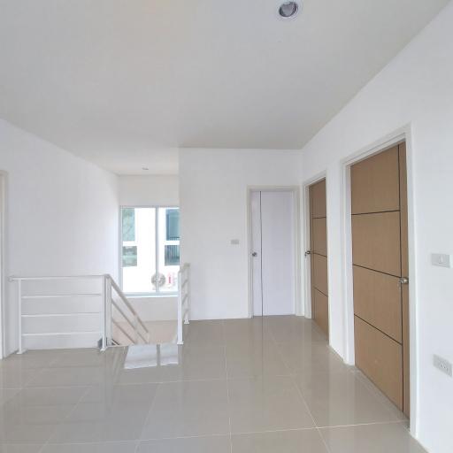 Spacious and well-lit empty room with tiled flooring
