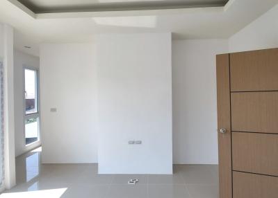 Spacious and bright unfurnished room with large window and tiled flooring