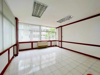 Spacious unfurnished room with large windows and tiled flooring