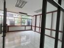 Spacious and well-lit office space with large windows and tiled flooring