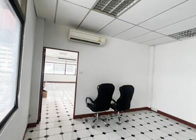 Spacious office interior with geometric floor tiles and large windows
