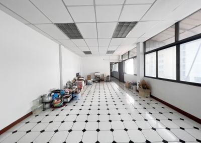 Spacious unfurnished interior of a building with large windows and tiled floor