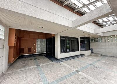 Exterior view of the building entrance with glass doors and tiled flooring