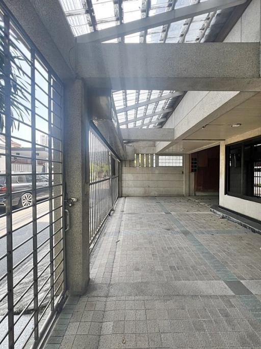 Spacious and well-lit building entrance with tiled flooring and modern design