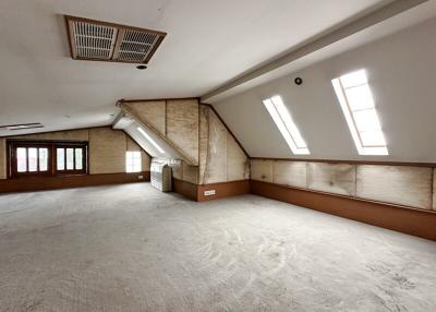 Spacious converted attic room with natural light