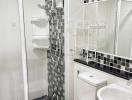 Modern white and black tiled bathroom with shower cabin