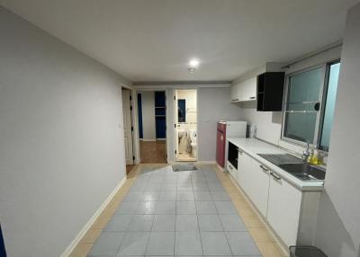 Modern kitchen with open plan layout extending to a laundry area