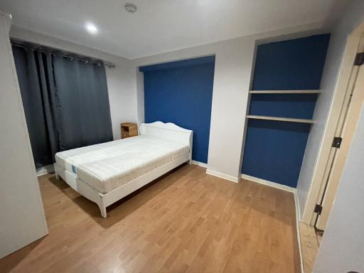 Cozy bedroom with a single bed and built-in shelves