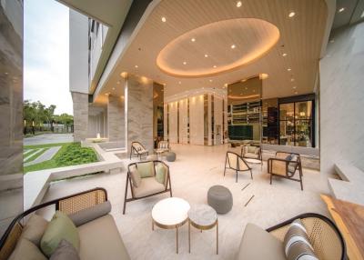 Spacious and modern open-air lobby with comfortable seating and marble floors