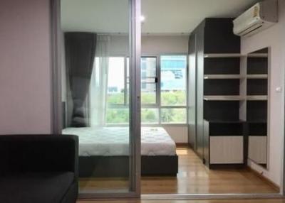 Modern bedroom with a large window and balcony access