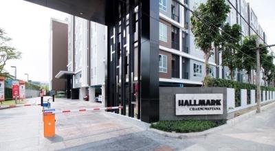 Modern residential building entrance with a signboard