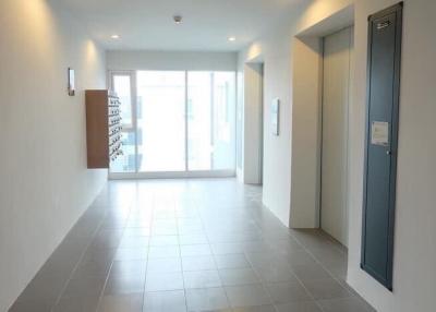Spacious, well-lit entryway of a modern building with tiled flooring