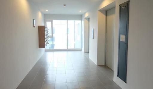 Spacious, well-lit entryway of a modern building with tiled flooring