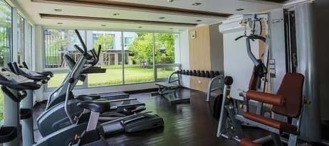 Home gym area with exercise equipment and large windows