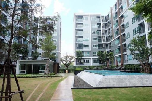 Modern apartment building with garden and swimming pool