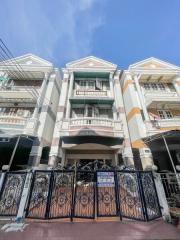 Front view of a multi-story residential building with gated entrance