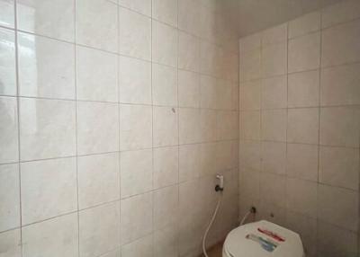 Compact bathroom with tiled walls