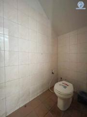 Compact bathroom with tiled walls