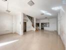 Spacious and empty interior of a building with tiled floors and staircase