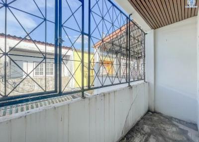 Small balcony with protective railing and urban view