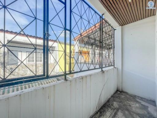 Small balcony with protective railing and urban view