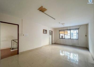 Spacious unfurnished living room with tile flooring and large windows