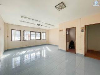 Spacious and well-lit empty room with tiled flooring and multiple windows