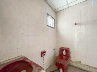 Compact bathroom with basic fixtures and wall tiles