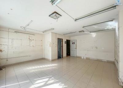 Spacious empty interior of a building with tiled floors and natural lighting