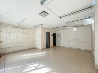 Spacious empty interior of a building with tiled floors and natural lighting