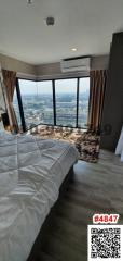 Modern bedroom with large windows and city view