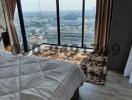 Modern bedroom with large windows and city view