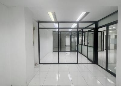Spacious commercial building interior with glass partitions and fluorescent lighting