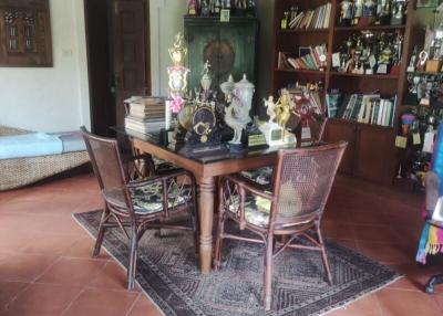 Cozy dining area with wooden furniture and decorative shelf