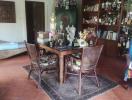 Cozy dining area with wooden furniture and decorative shelf